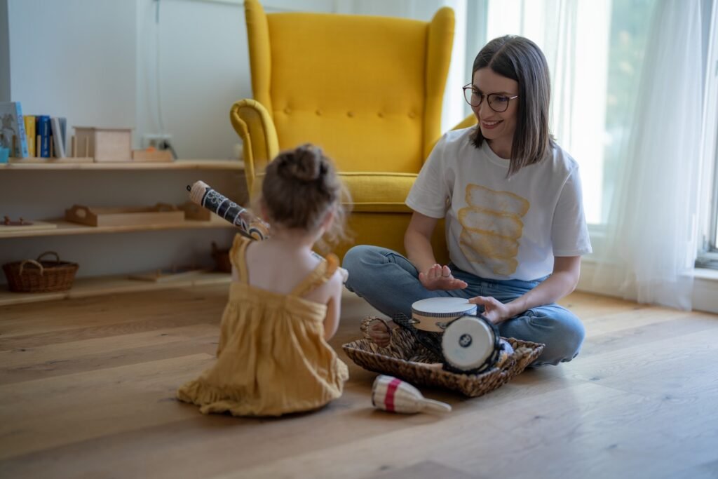 A parent and a child sitting on the floor