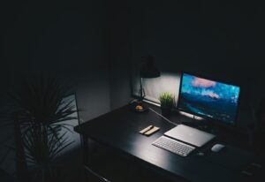 a desk with a computer monitor and keyboard on it dark internet