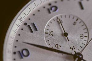 a close up of a silver watch face online time out